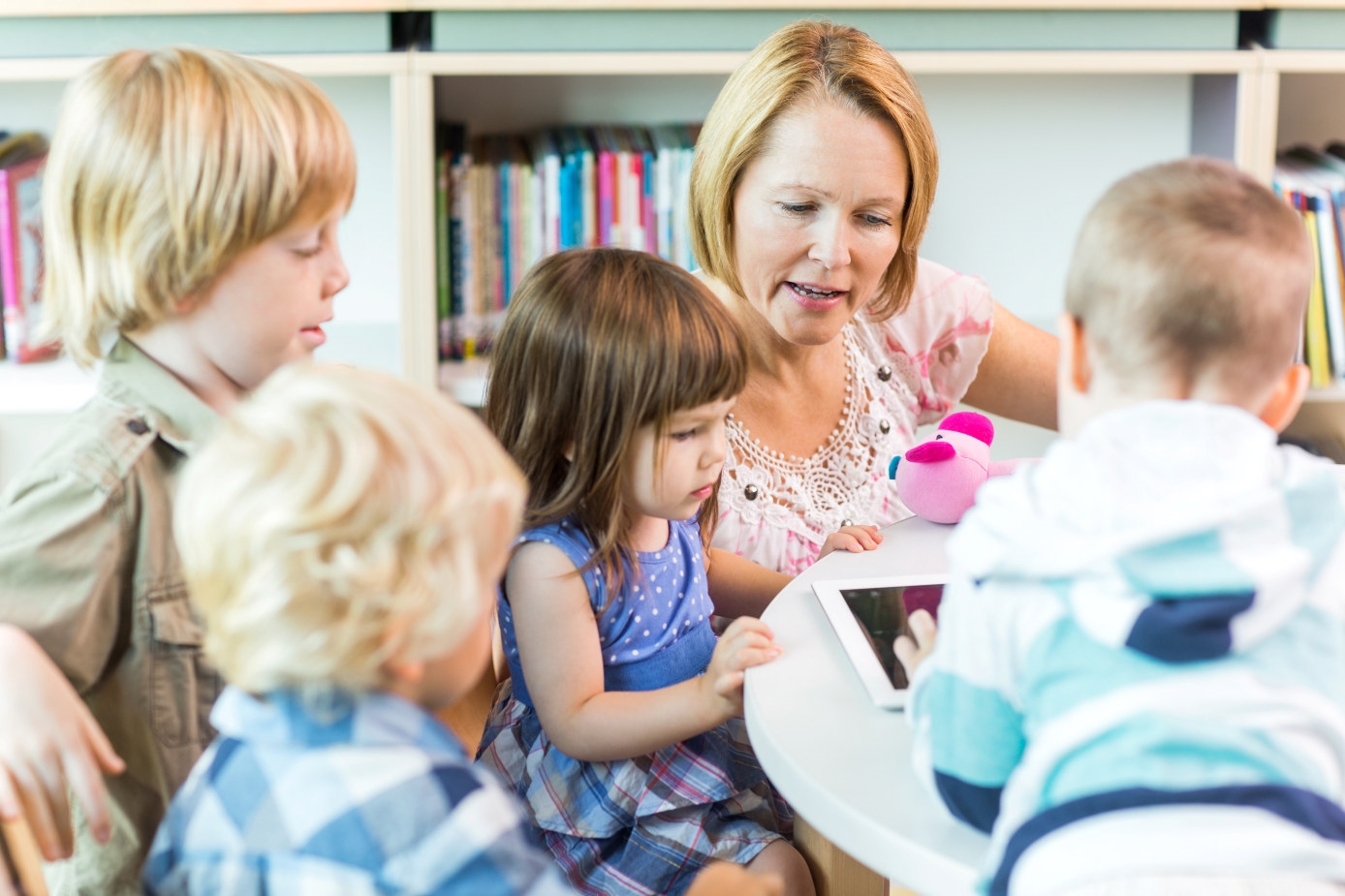 7701657-school-children-with-teacher-using-digital-tablet.jpg