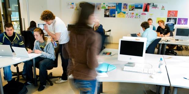 Elever som samarbeider foran PC i klasserom. Foto.